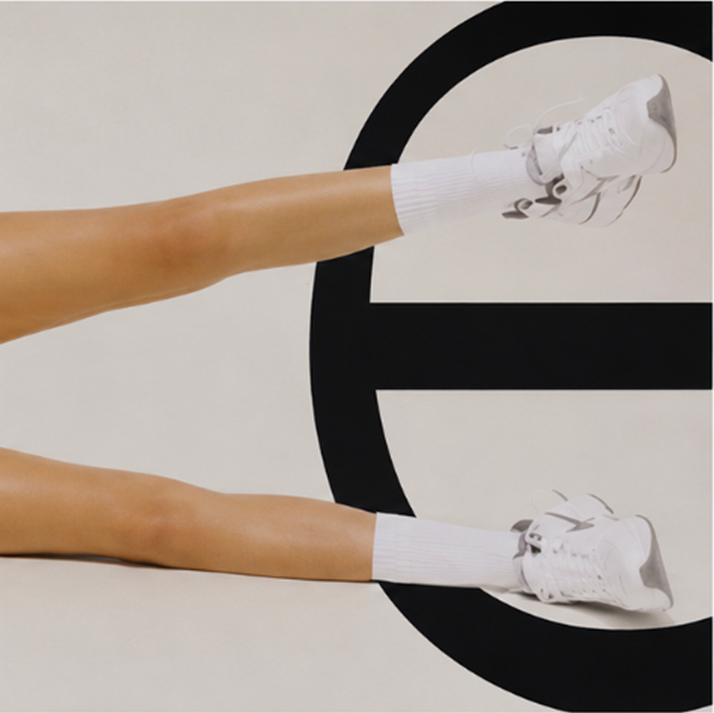 Extended legs layered with an oversized letter E